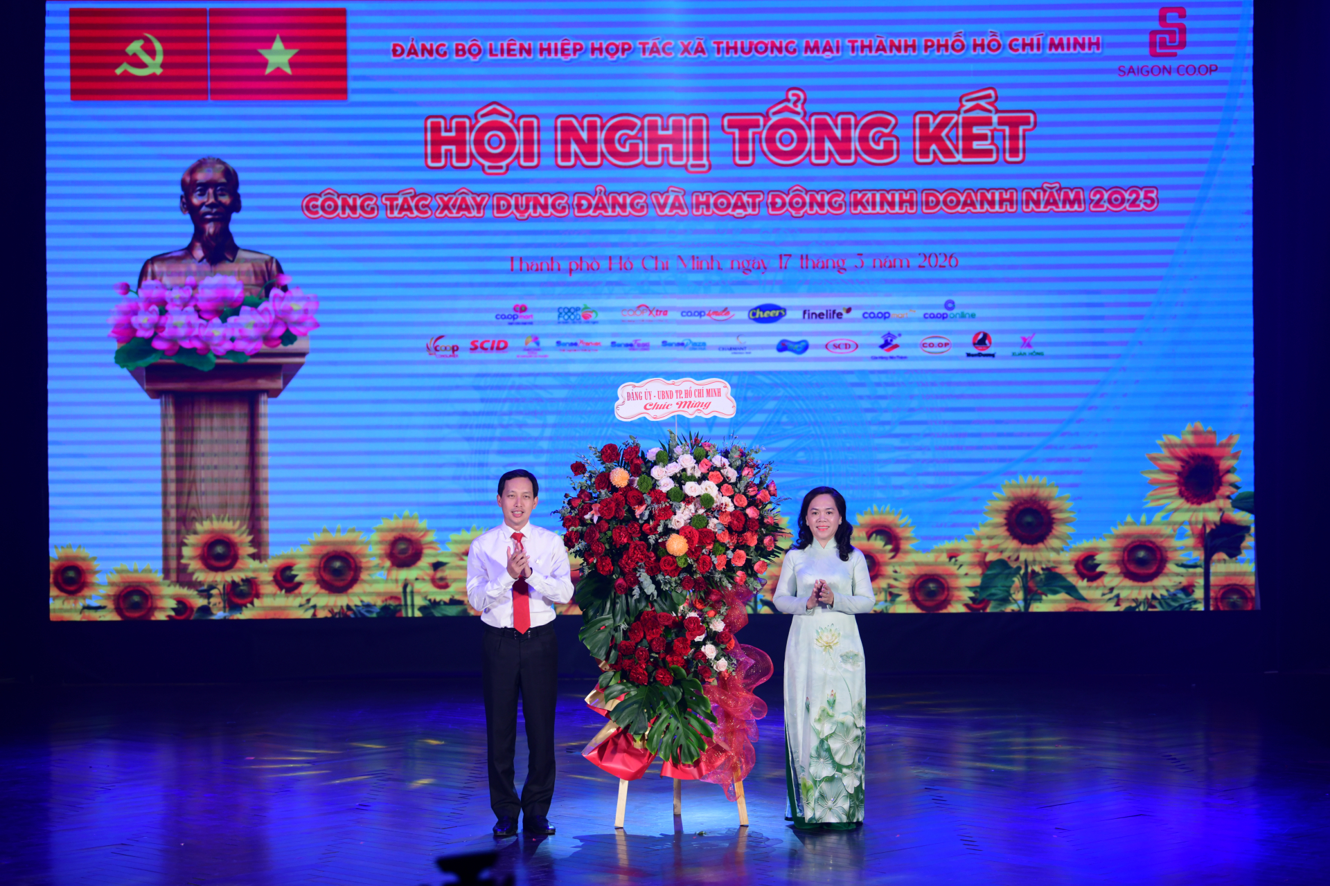 Đồng chí Vũ Anh Khoa, Bí thư Đảng ủy, Chủ tịch HĐQT Saigon Co.op đại diện nhận hoa chúc mừng từ Đảng ủy, UBND TP.HCM