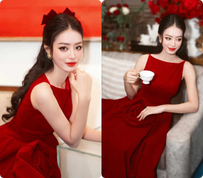 Á hậu Khánh Linh xinh như tiểu thư đài các, cô diện bộ đầm đỏ yêu kiều, mái tóc điểm xuyết nơ xinh xắn.