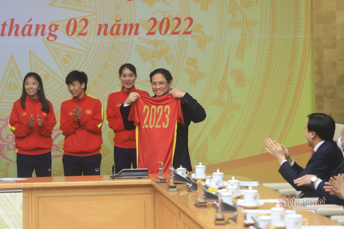 Thủ tướng thích thú với món quà đội tuyển tặng là áo thi đấu có chữ ký của các thành viên.
