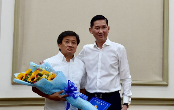 Ông Đoàn Ngọc Hải (trái) nhận hoa chúc mừng tại buổi trao quyết định bổ nhiệm sáng 4/6. Ảnh: Tuổi Trẻ.