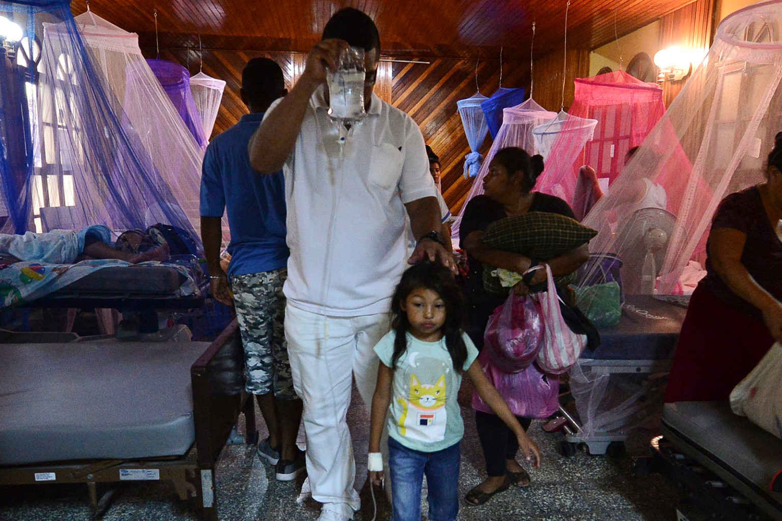   Bệnh nhân bị sốt xuất huyết được hỗ trợ trong nhà nguyện của Bệnh viện Roberto Suazo Córdova ở La Paz, Honduras, vào ngày 24 tháng 7. Một dòng người nhiễm bệnh sốt xuất huyết đã tràn vào các bệnh viện công ở Honduras trong trường hợp các cơ quan y tế mô tả là trường hợp khẩn cấp tồi tệ nhất của 50 năm qua vì virus đã giết chết 54 người, chủ yếu là trẻ em.  