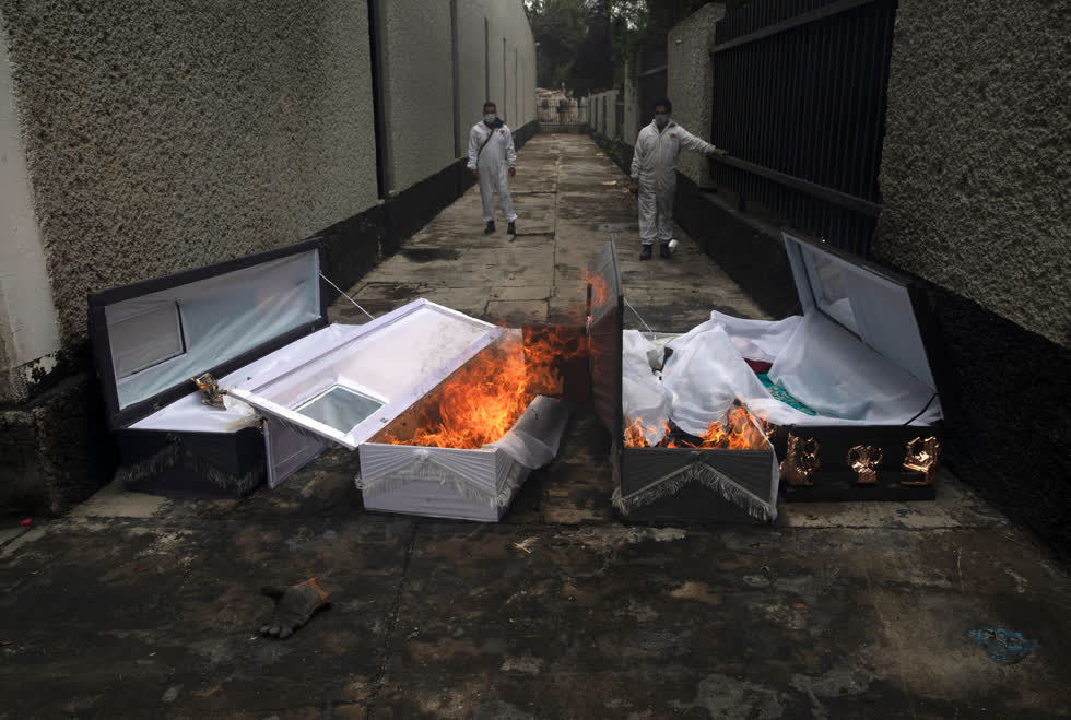Thành phố Mexico, ngày 24/6/2020. Các công nhân đã đốt quan tài của các nạn nhân COVID-19 sau khi xác của họ được hỏa táng. Mexico là một trong những quốc gia có tỷ lệ tử vong do coronavirus cao nhất trên thế giới. Ảnh: Marco Ugarte/Associated Press