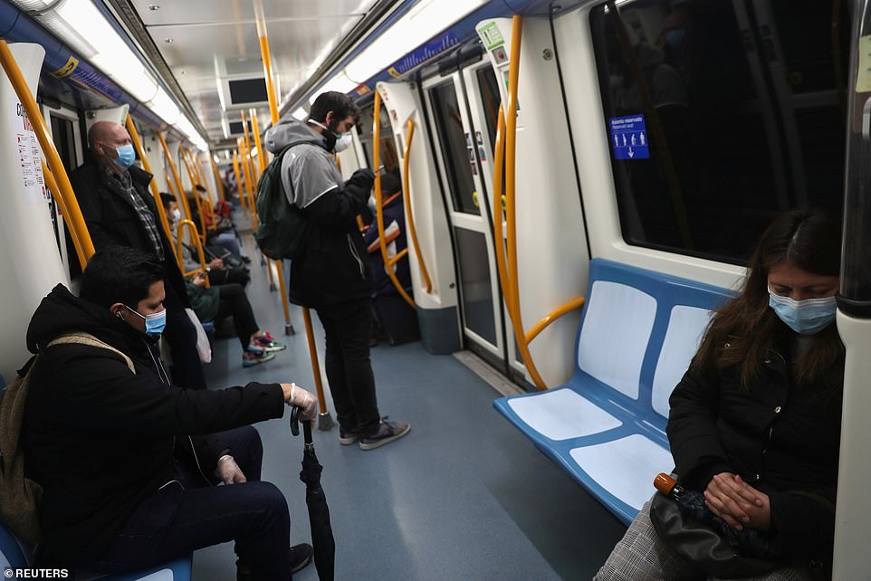 27121816-8213499-Passengers_keep_their_distance_riding_the_metro_in_Madrid_as_non-a-26_1586796545901