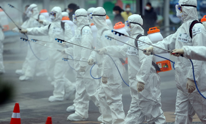 Binh sĩ Hàn Quốc phun thuốc khử trùng nhà ga xe lửa ở thành phố Daegu hôm 29/2. Ảnh: Reuters 