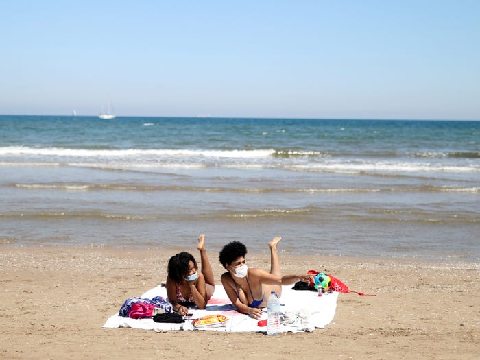 Những người đi biển tại Valencia, Tây Ban Nha vẫn phải đeo khẩu trang bảo vệ mình. Ảnh: Reuters.