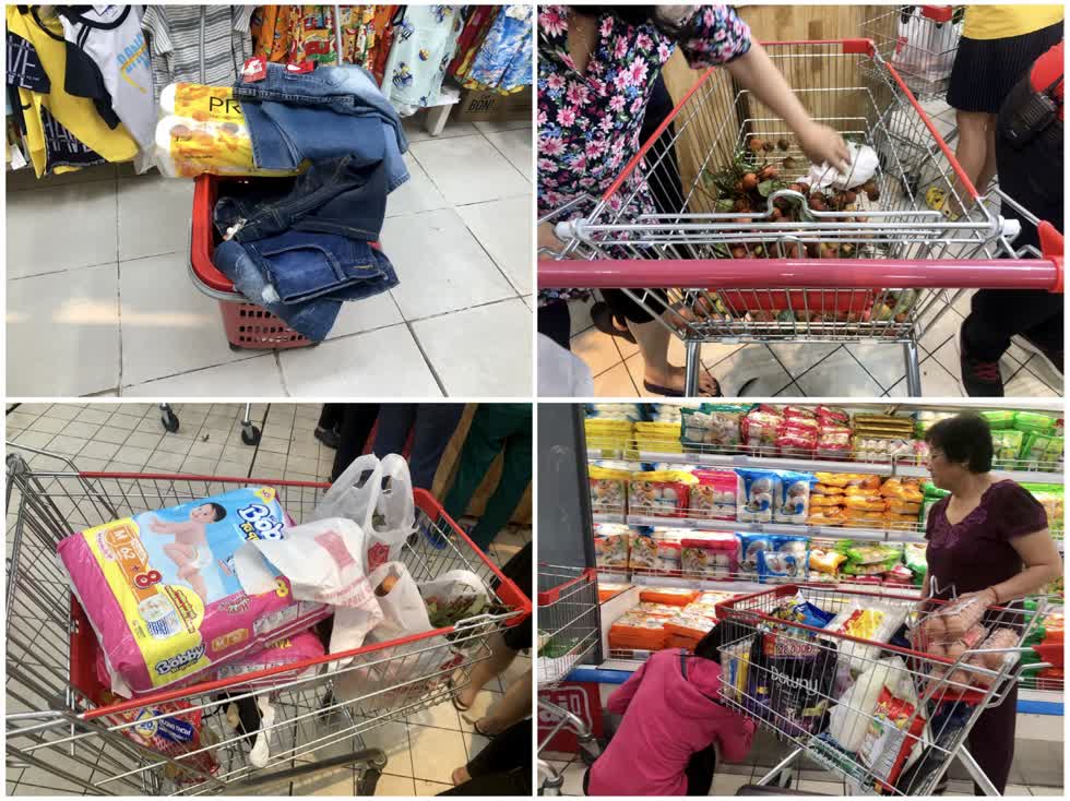   Tranh thủ đợt giảm giá 20 - 50% của siêu thị BigC Miền Đông, người dân tranh gom hàng, chất đầy xe đẩy.   