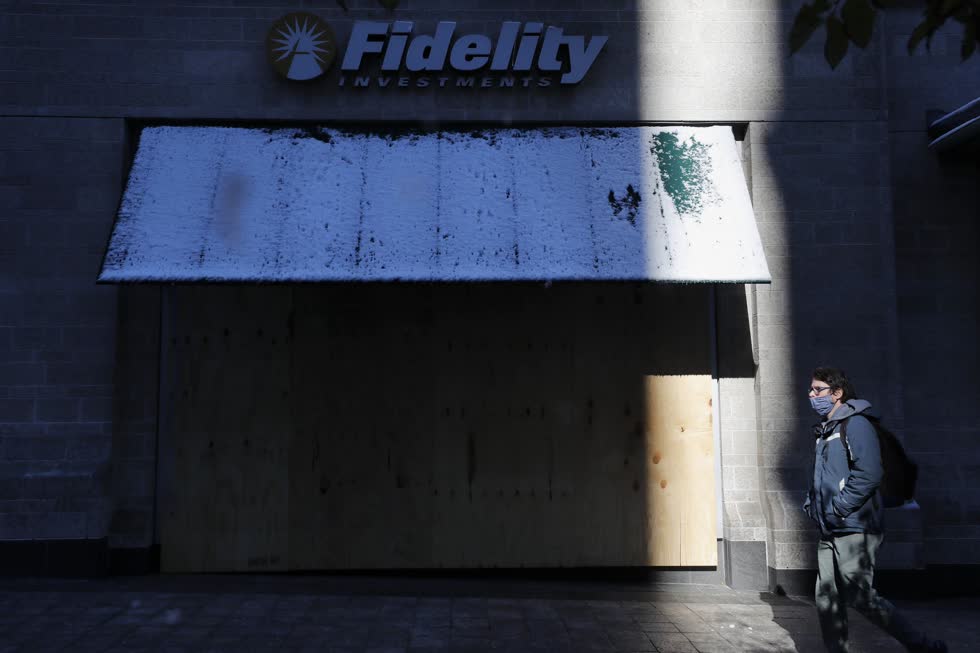 Một người đàn ông đi ngang qua một chi nhánh mới của Fidelity Investments trên Phố Boylston. Ảnh: AP
