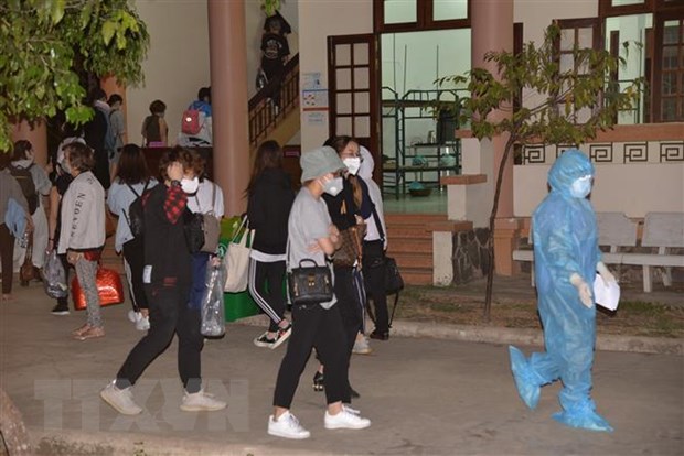 Nhân viên y tế hướng dẫn công dân trở về vào khu vực cách ly tại Tiền Giang. Ảnh: Nam Thái/TTXVN 