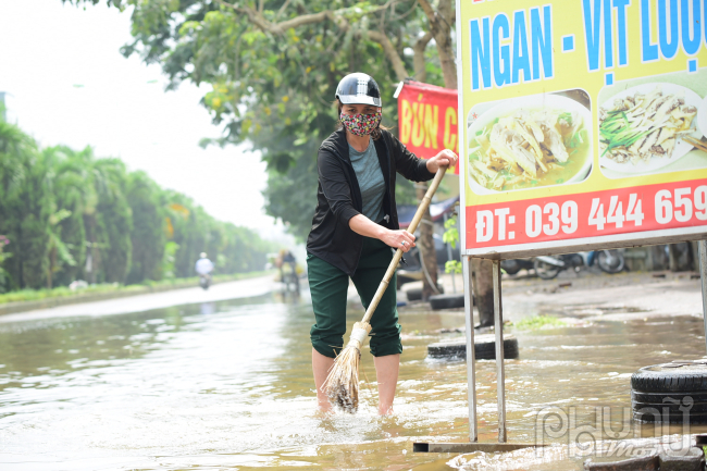 Chủ quán bún miến Thanh Giang đang dọn rửa lại quán bị ngập nước, cô than thở nước ngập hơn 3 ngày này không buôn bán được gì được, không hiểu sao ở Hà Nội mà ngập hơn cả vùng quê.