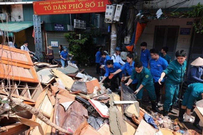   Lực lượng thanh niên tình nguyện tại phường Chương Dương (quận Hoàn Kiếm, Hà Nội) hỗ trợ thu gọn, vận chuyển đồ đạc bị hư hỏng của người dân do ảnh hưởng của cơn bão số 3, ngày 14/9/2024. Ảnh: Hoàng Hiếu – TTXVN  