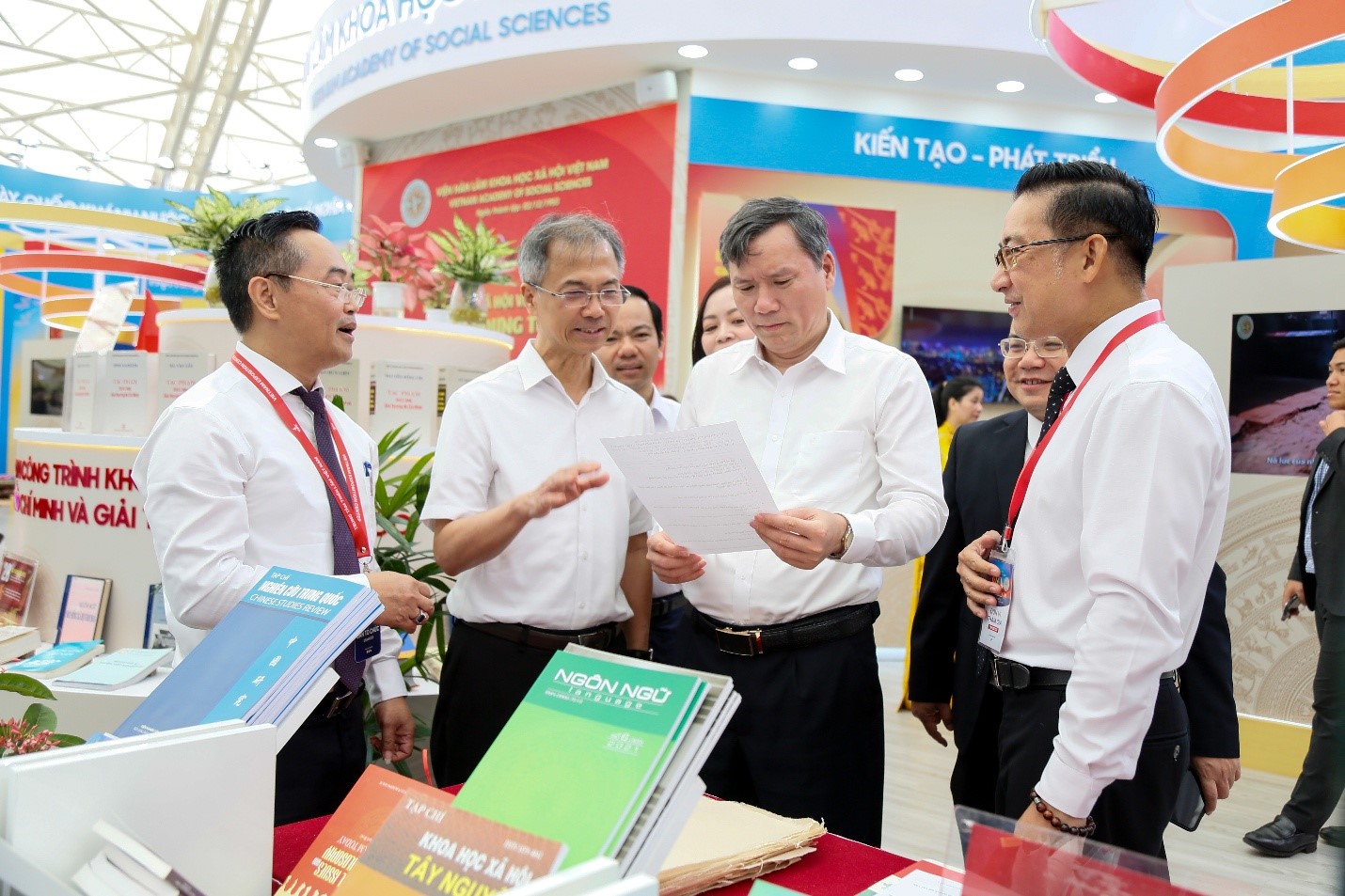 Chủ tịch Viện Hàn lâm Lê Văn Lợi nghe giới thiệu về cách thức tổ chức cho khách tham quan tìm hiểu và trải nghiệm tại gian triển lãm của Viện Hàn lâm