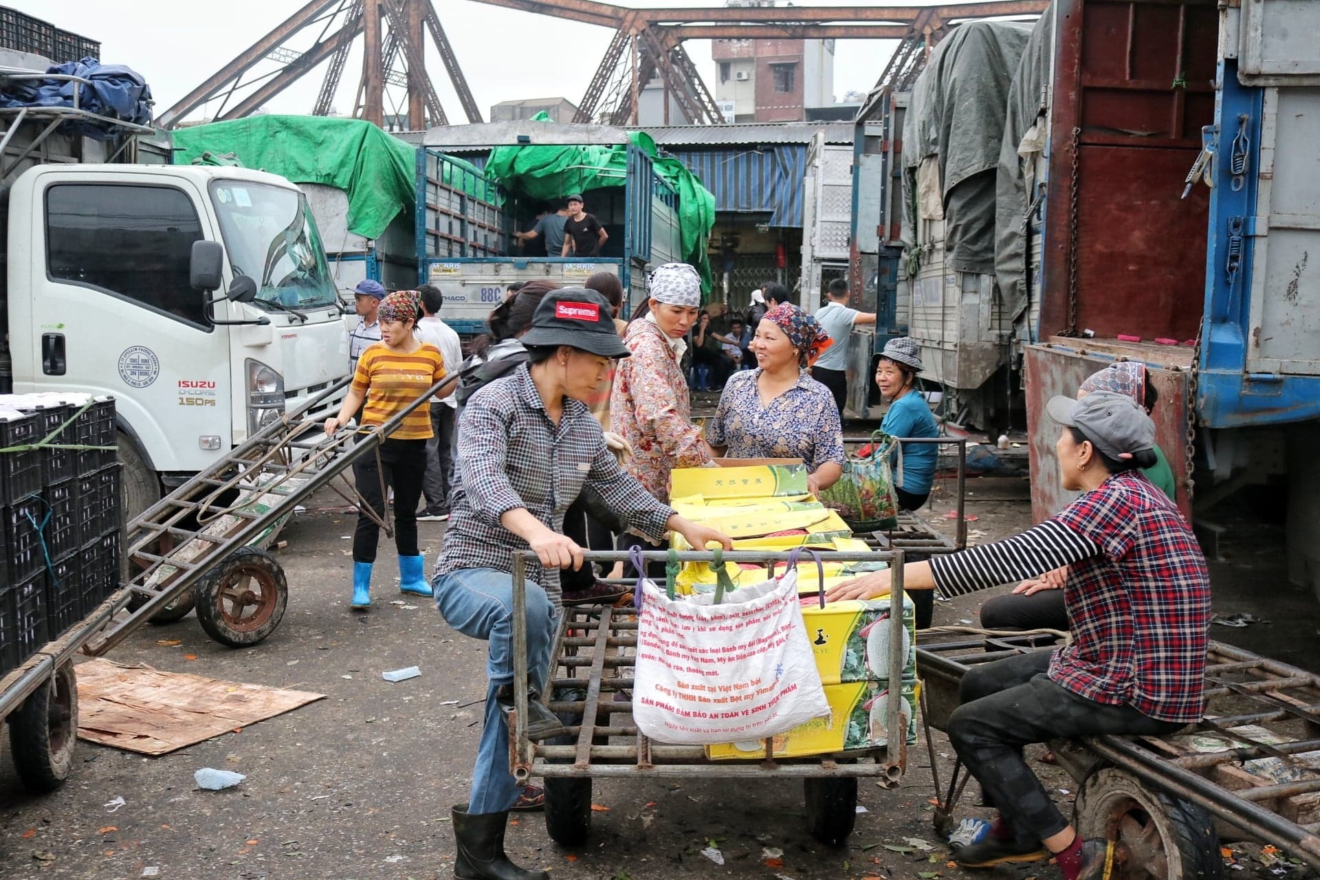 Những người làm nghề cửu vạn ở chợ đầu mối Long Biên (Hà Nội) phần lớn đều là phụ nữ. Ảnh: BLĐ