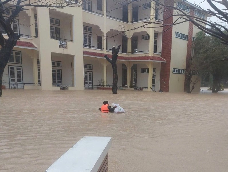   Thầy giáo Trường Cao đẳng Kỹ thuật Công nghệ Quy Nhơn (Gia Lai) bơi vào cứu trợ  mì tôm, bánh mì và nước uống cho sinh viên đang bị cô lập ở bên trong   