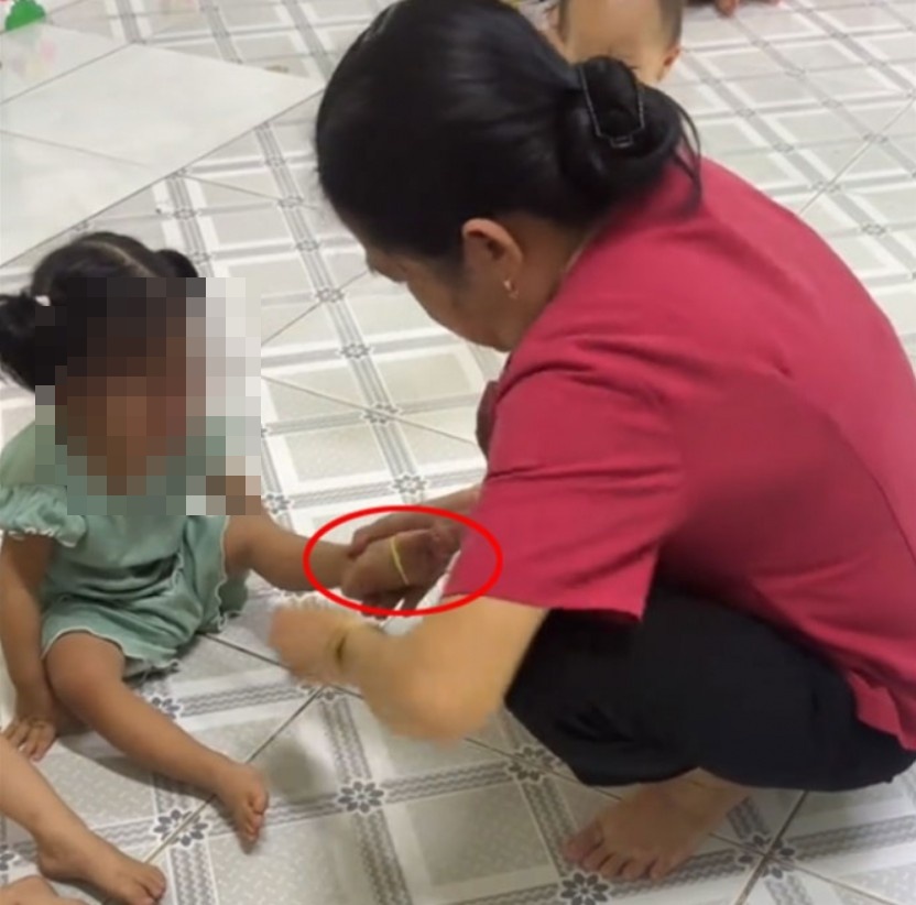 Người phụ nữ dùng dây thun để bạo hành các bé - Ảnh cắt từ clip