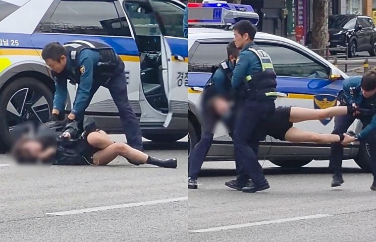 Người phụ nữ được cảnh sát đưa khỏi một tuyến đường đông đúc ở quận Gangnam, phía nam Seoul, hôm 26/10. (Ảnh: Threads)