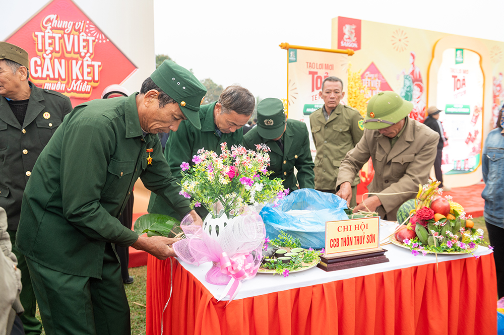 Các cựu chiến binh tại tỉnh Nghệ An tham gia phần thi gói bánh chưng và bày mâm cỗ trong sự kiện.