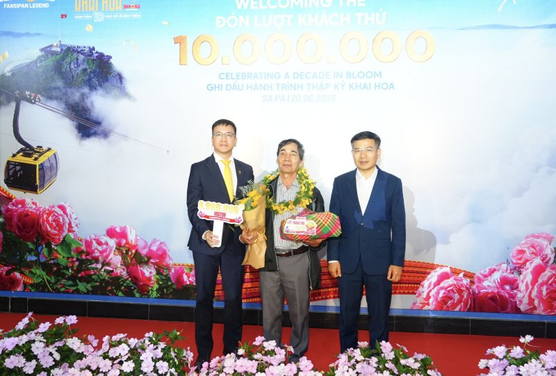 Ông Nguyễn Anh Vũ – Phó Tổng quản lý Sun World Fansipan Legend (bên trái) và ông Đỗ Văn Tân - Bí Thư Đảng ủy - Chủ tịch HĐND Xã Tả Van (bên phải) trao quà cho vị khách thứ 9.999.999.