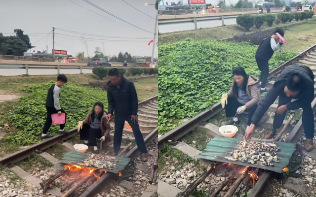 Hình ảnh cặp đôi vô tư nướng đồ ăn tại khu vực đường ray tàu hỏa (Ảnh cắt từ clip)