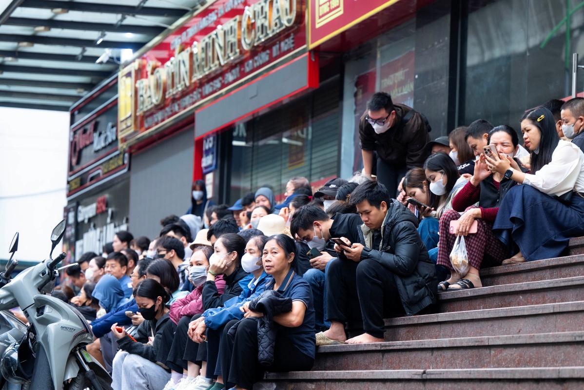 Mọi người tranh thủ ngồi nghỉ ngơi, lướt điện thoại cập nhật giá vàng trong lúc chờ đợi