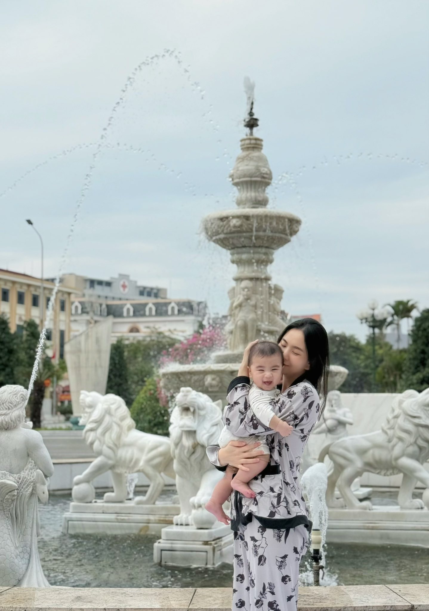 Khuôn viên rộng lớn với lối đi lát đá, hàng cây xanh và đài phun nước.