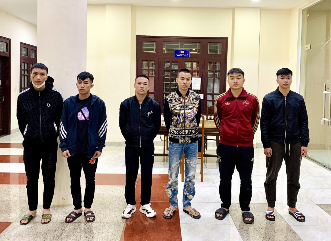 Đối tượng cầm đầu Nguyễn Văn Tuấn (mang áo khoác hoạ tiết- quần jean xanh, đứng thứ ba từ phải qua) cùng đồng bọn tại cơ quan Công an (Ảnh: Công an Quảng Trị).