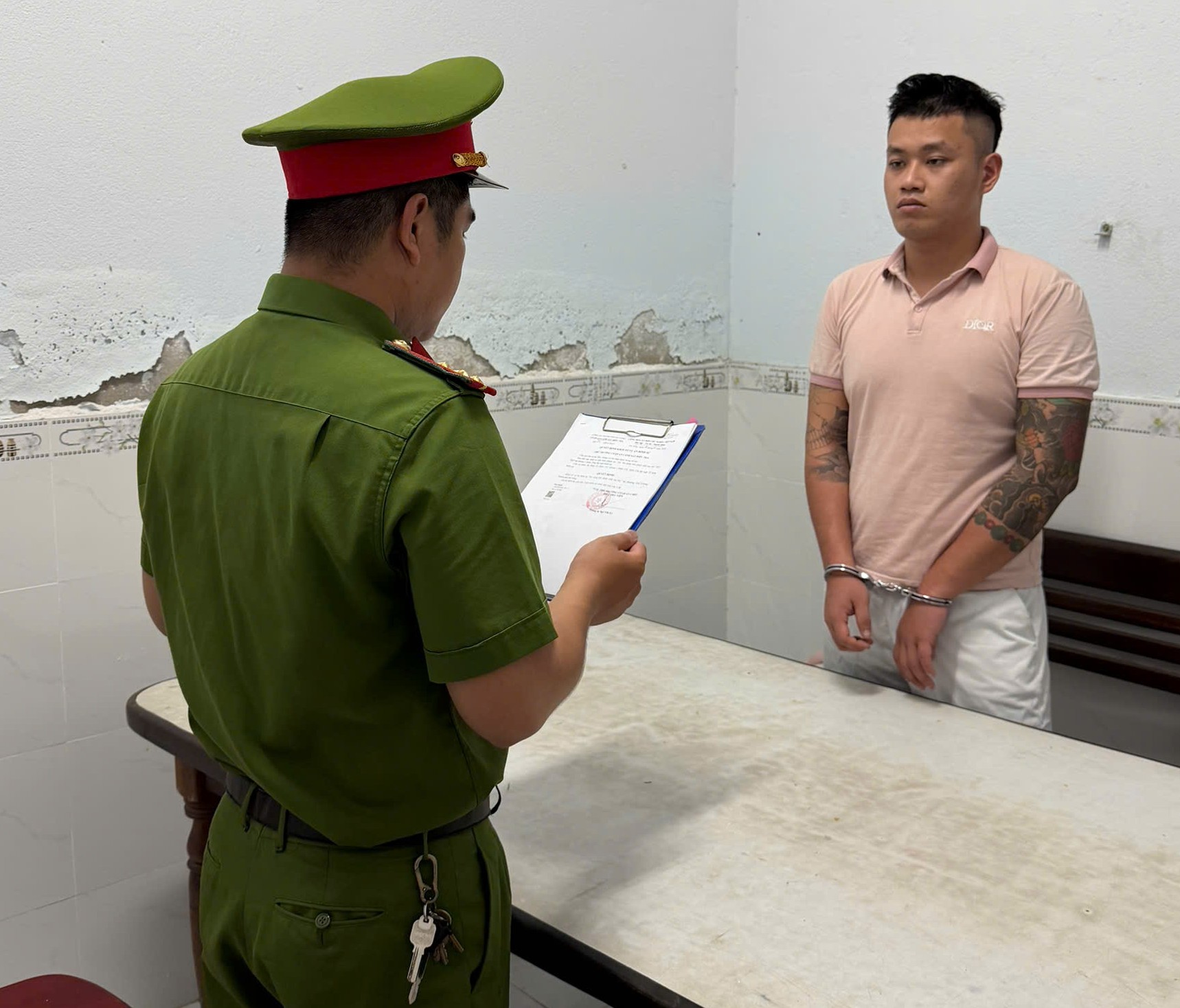 Đại diện cơ quan điều tra đọc lệnh tố tụng đối với Phạm Thiện Tâm (Ảnh: Công an Đà Nẵng).