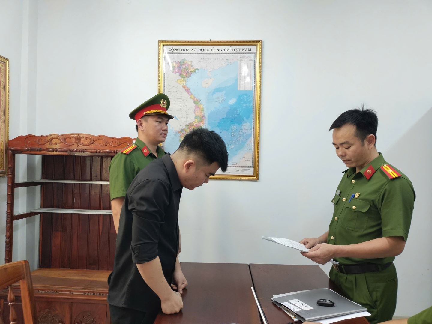 Đối tượng Nguyễn Phúc Linh (áo màu đen) tại cơ quan Công an - Ảnh: Công an Khánh Hòa