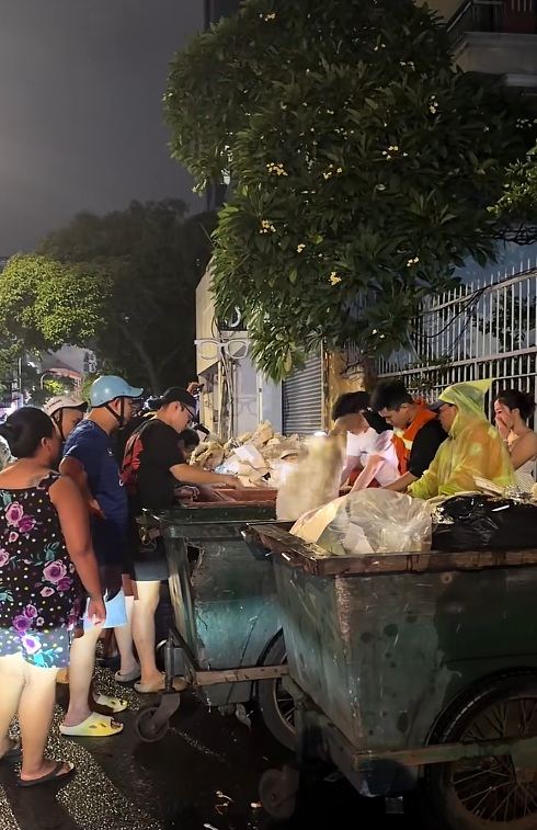 Nhóm nhân viên quán ăn lục tìm đồ cho khách trong 3 thùng rác. (Ảnh cắt từ clip)