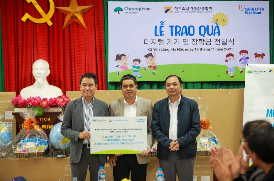 Ông Lee Hyung-gak, Chủ tịch Hiệp hội Công nghệ Mua sắm Công và ông Nguyễn Sáng, Phó giám đốc - Chương trình Doanh nghiệp Xã hội Cánh Diều Việt Nam trao quà cho trường Tiểu học Chu Phan