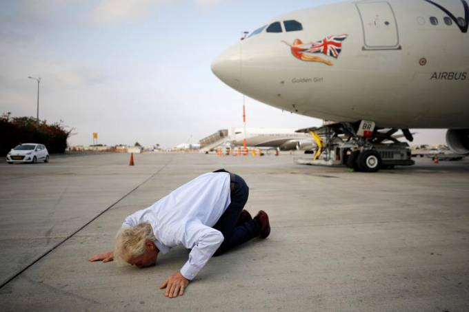 Ông chủ Virgin Richard Branson hôn lên mặt đất khi hạ cánh xuống sân bay quốc tế Ben Gurion gần Tel Aviv, Israel vào 23/10/ Ảnh: Amir Cohen