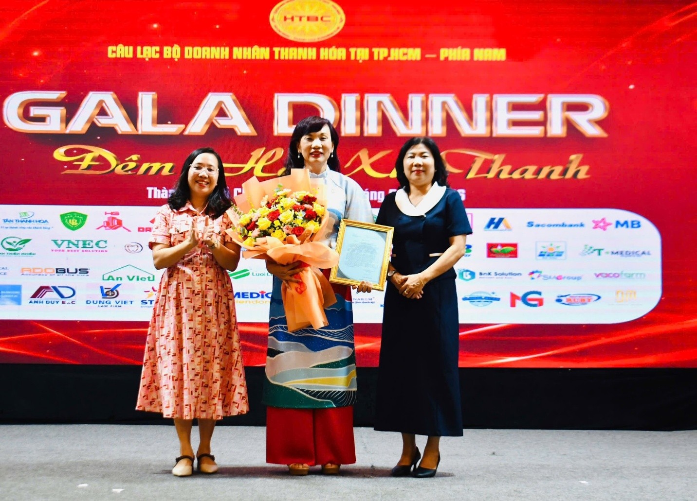 Bà Nguyễn Thị Mai Diễm, Chủ tịch Ủy ban MTTQ Việt Nam phường Rạch Dừa và bà Trần Thị Xuân, Phó Chủ tịch UBND phường Rạch Dừa tặng hoa và trao thư cảm ơn cho Bà Nguyễn Thị Hồng Liên (giữa), Thành viên HĐQT, Phó TGĐ Tập đoàn Đại Dũng - đơn vị nhận đỡ đầu 20 trẻ mồ côi, trẻ có hoàn cảnh đặc biệt khó khăn tại phường Rạch Dừa