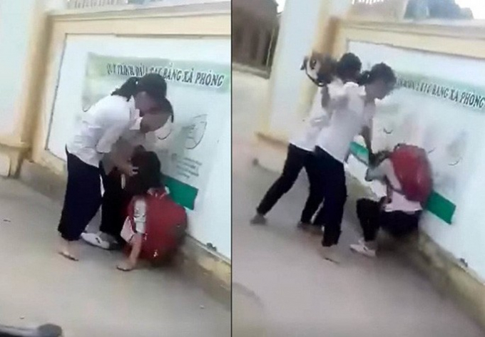   Hình ảnh một nữ sinh bị nhóm bạn đánh hội đồng trước cổng trường - Ảnh cắt từ clip  