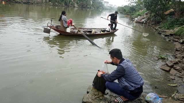 Sau lễ cúng ông Công ông Táo, nhiều người dân TP Vinh (Nghệ An) mang cá chép ra khu vực dưới chân cầu Cửa Tiền thuộc sông Vinh để thả.