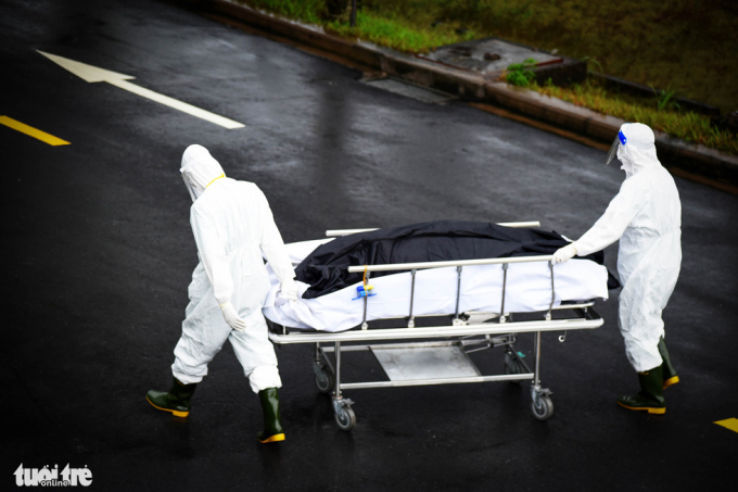   Nhân viên y tế Bệnh viện hồi sức COVID-19 (TP Thủ Đức) đưa một bệnh nhân tử vong vì COVID-19 đến kho bảo quản đông lạnh - Ảnh: DUYÊN PHAN  
