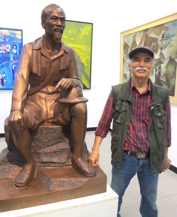 Nhà điêu khắc Nguyễn Phú Cường bên tác phẩm tượng đồng “Bác Hồ đi chiến dịch” do ông sáng tác. Ảnh: L.Q.V 