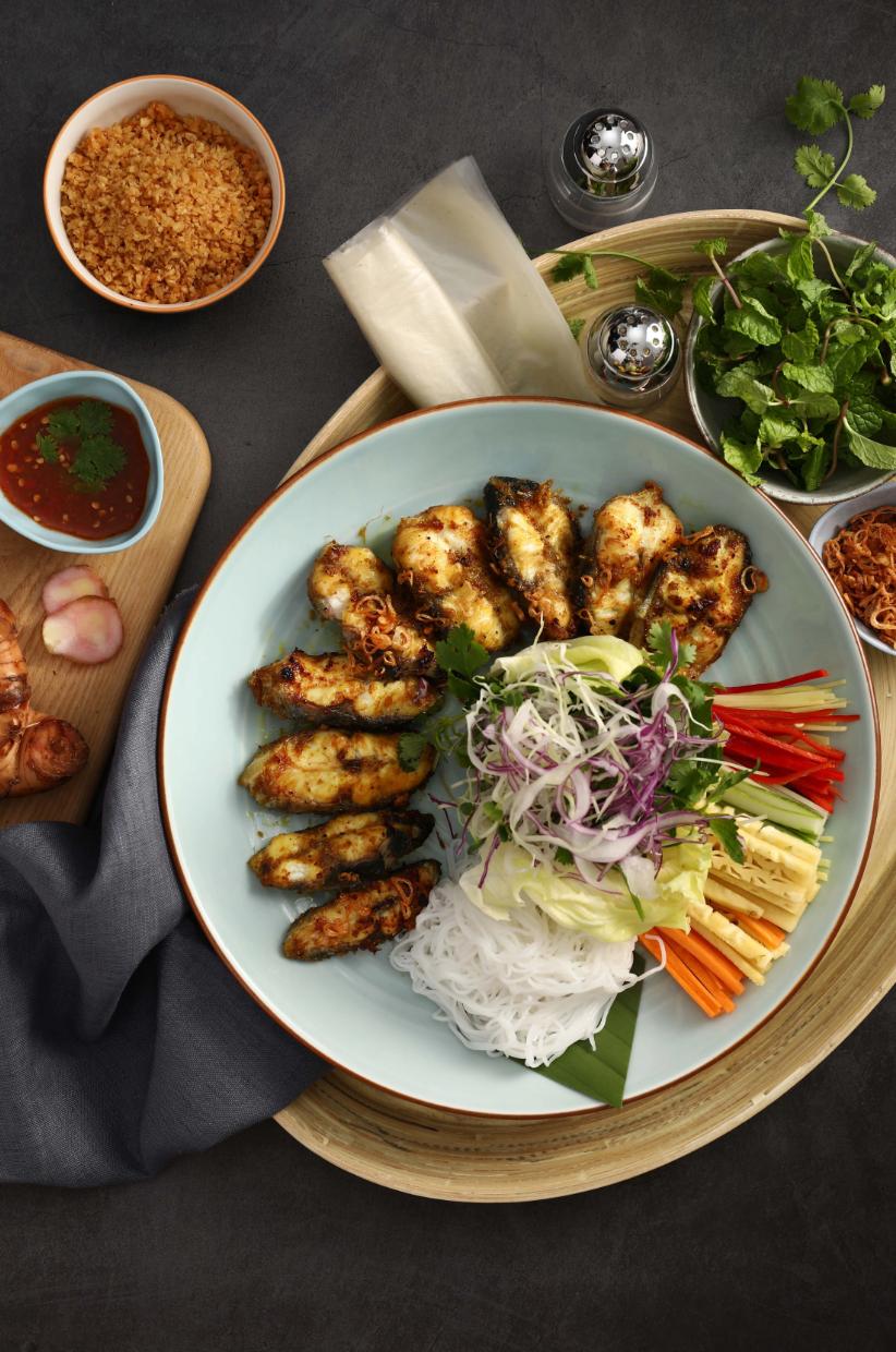 Món cá nướng được cuốn cùng bún, dứa, cà rốt, rau thơm chấm nước mắm. Ảnh: Ngon Garden