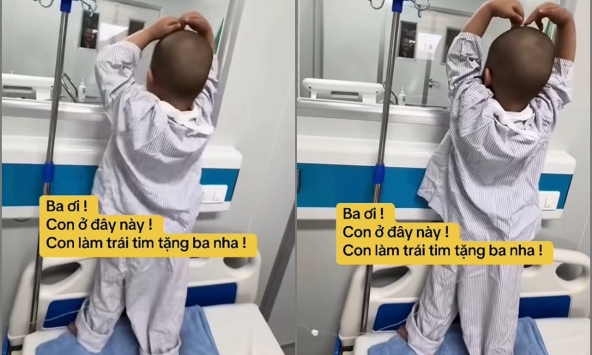Nhói lòng với clip chiến binh ung thư nhí kiễng chân nhún nhảy gửi trái tim qua ô cửa kính như động viên bố: Ba ơi, đừng sợ!